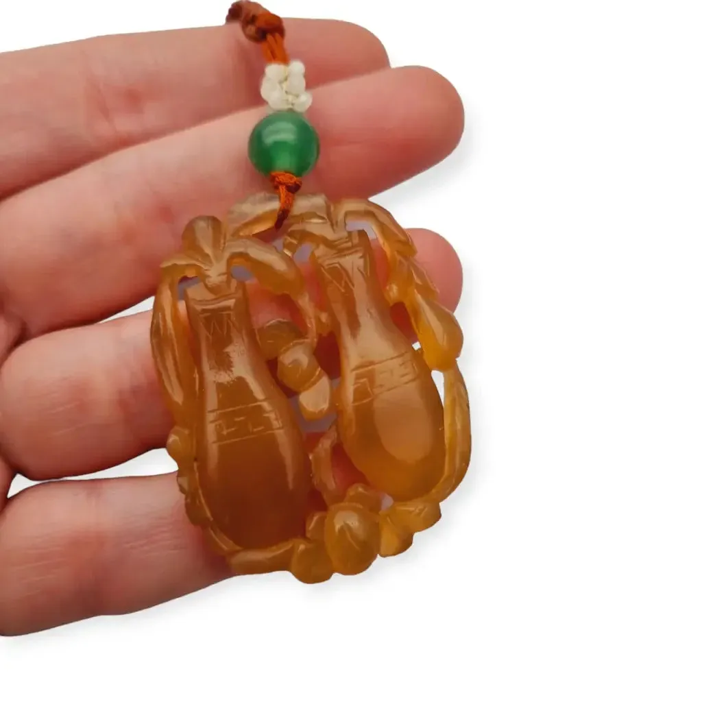 Chinese orange jadeite jade necklace with two vases, carved on both sides.