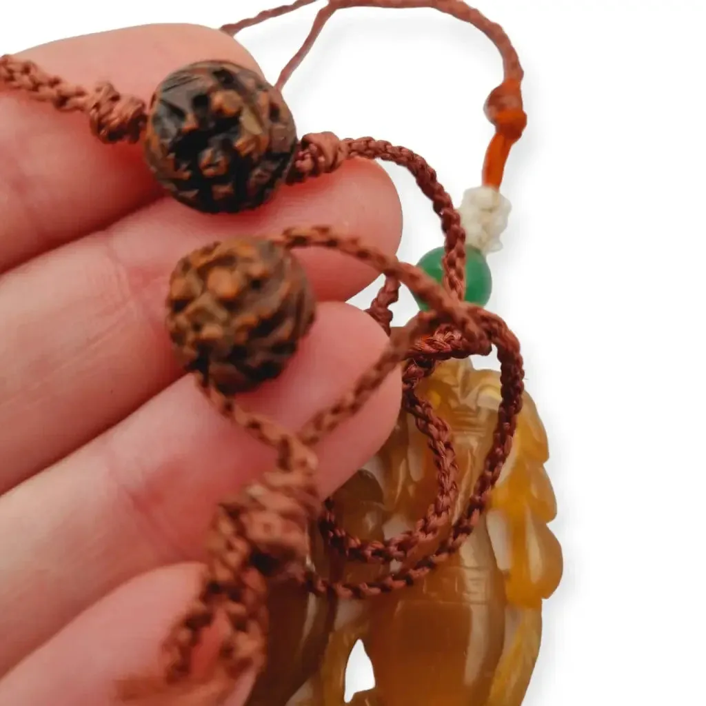 Chinese orange jadeite jade necklace with two vases, carved on both sides.